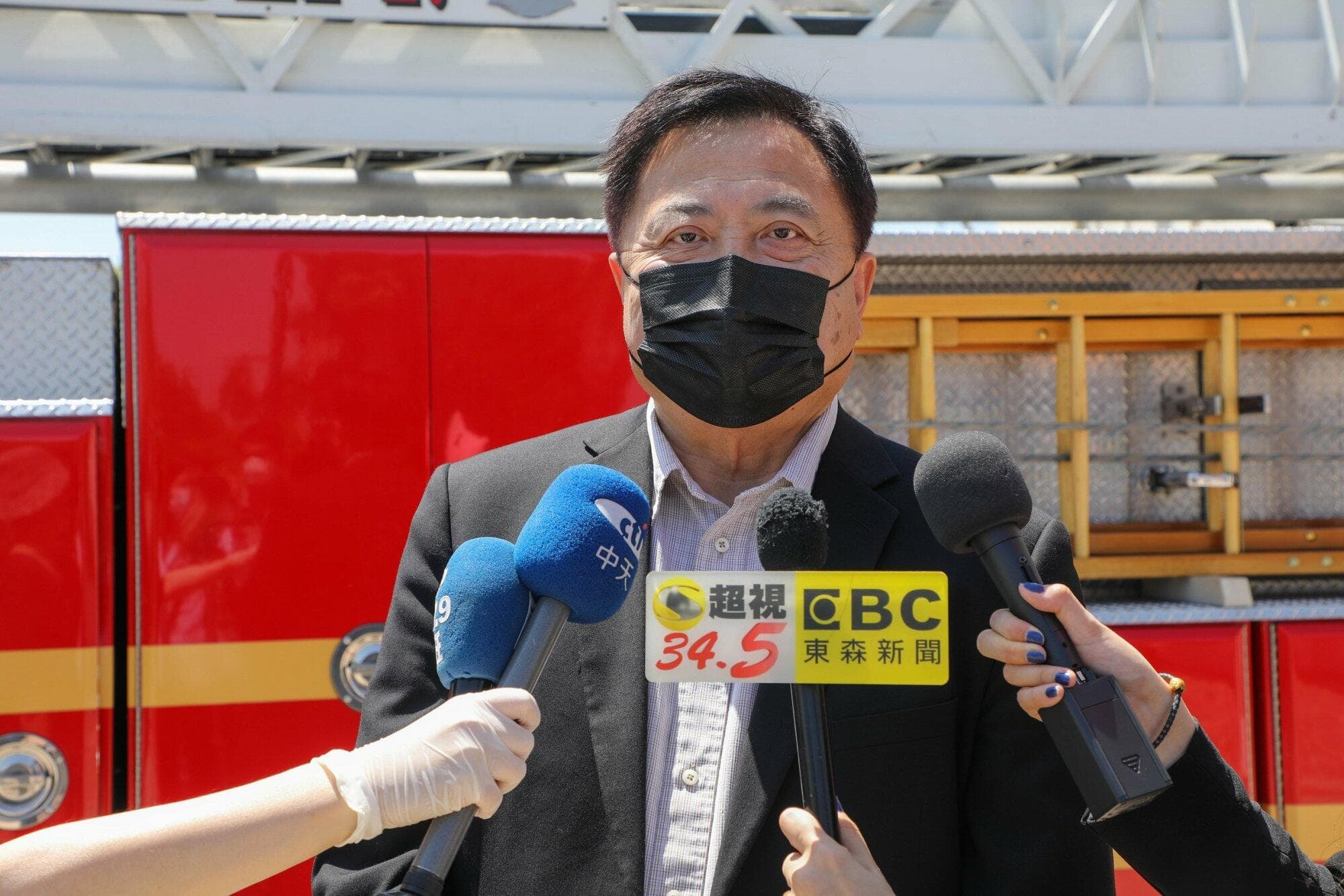 A media interview in front of a fire engine