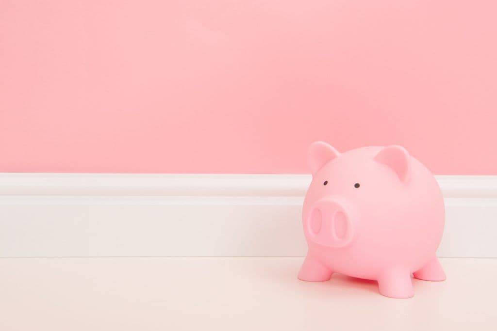 Pink piggy bank on a living room setting with a bank background