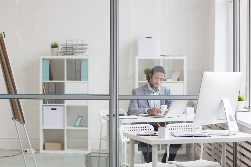 The photo shows a man is working in a transparent environment
